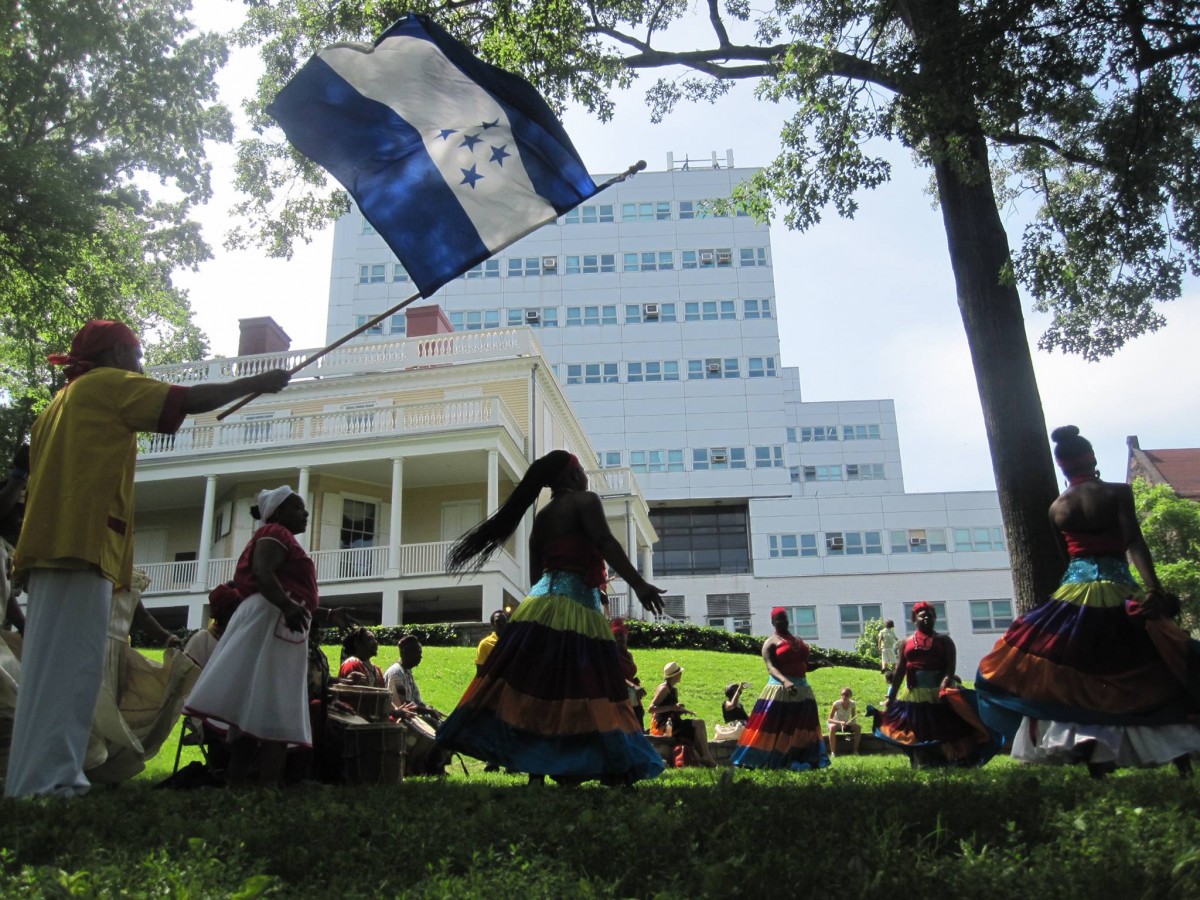 Colorful dancers on grass at Hamilton Grange National Memorial. 