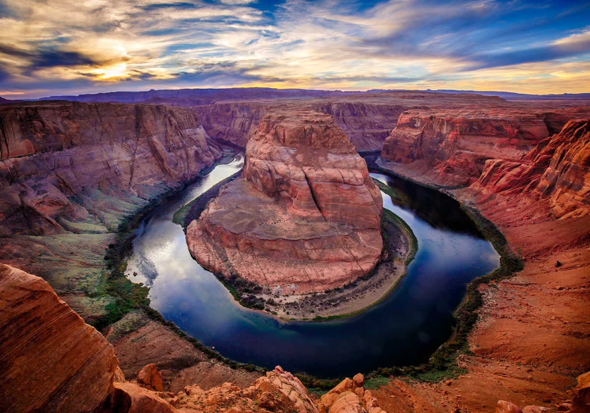 curving river cutting through red rocks