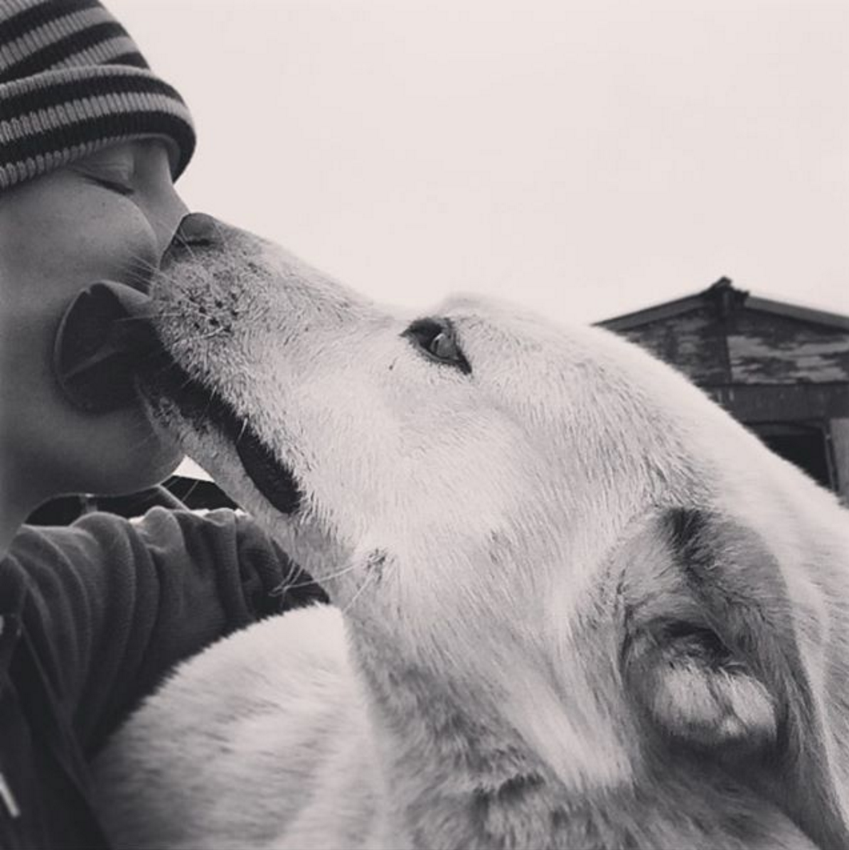 Jannelle with dog giving her a kiss on the cheek