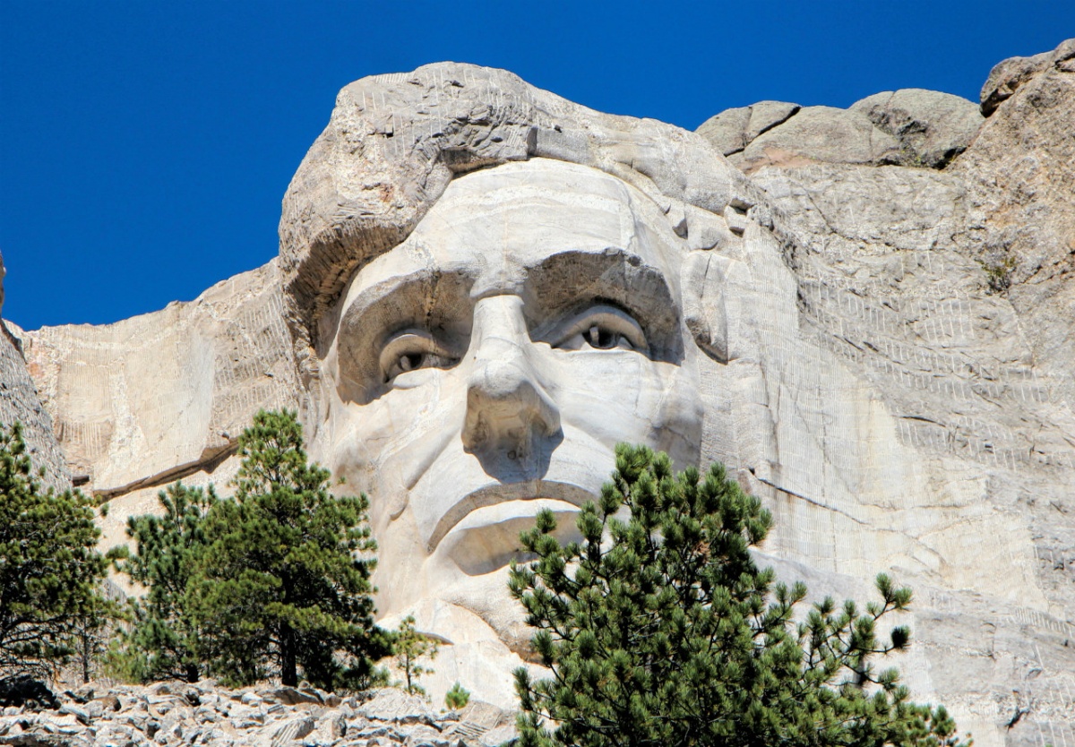 The sculpture of Abraham Lincoln's face looks out from the side of Mount Rushmore.