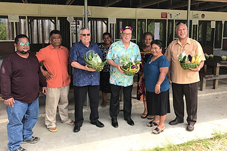 Nett Elementary School Vice Principal Maxson Mallarme; Pohnpei State Director of Education; DCM U.S. Embassy Ted Pierce; Assistant Secretary Domenech; OIA Director Nik Pula; and Nett Elementary School staff – Domenech and team are presented with baskets of Pohnpeian local food in the tradition of “lapw kopwou”, the Pohnpeian tradition of presenting food to visitors.