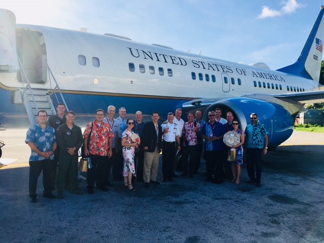 U.S. delegation poses in front of their airplane in Naru