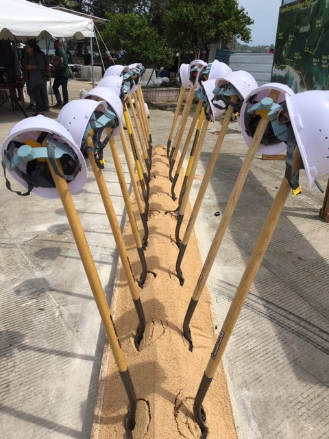 Shovels and hard hats lined up for the groundbreaking ceremony