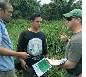 erwin Siregar of uSAiD leSTARi and Rio Ardi of the orangutan information Centre discuss wetland restoration with NPS hydrologist Peter Sharpe in Rawa Singkil Wildlife Reserve. 