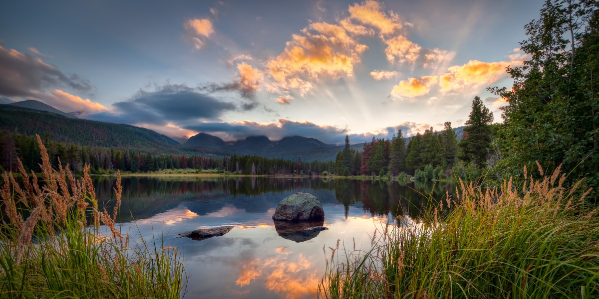 Sun rays stream out of the clouds over a lake