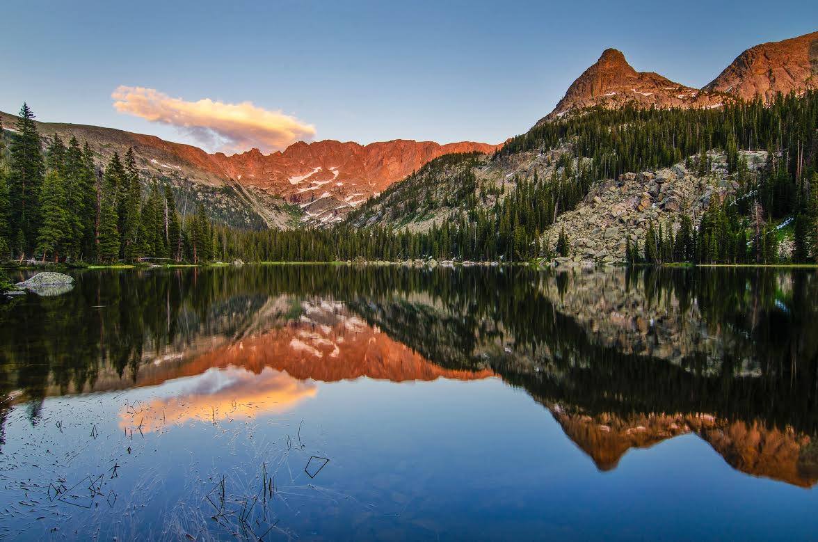 Orange glow on the mountain reflected in a lake