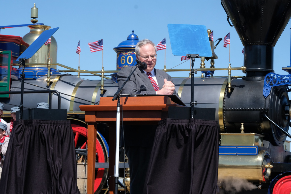 Secretary Bernhardt stands at a lectern delivering speech at the 150th Anniversary of Golden Spike in Brigham City, Utah. 