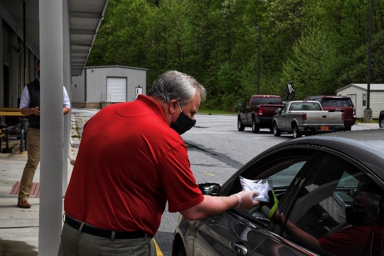 Secretary Bernhardt delivers cloth face coverings to a community member of the Eastern Band of Cherokee Indians in Cherokee, NC.