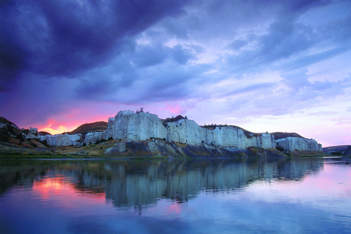 white cliffs reflected in flowing river