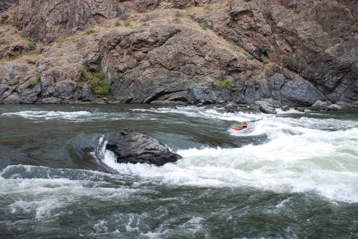 Kayaker navigates whitewater rapids. 
