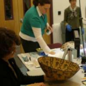 Examining Native American baskets from the Gibson and Colburn collection at the Interior Museum. (IM)